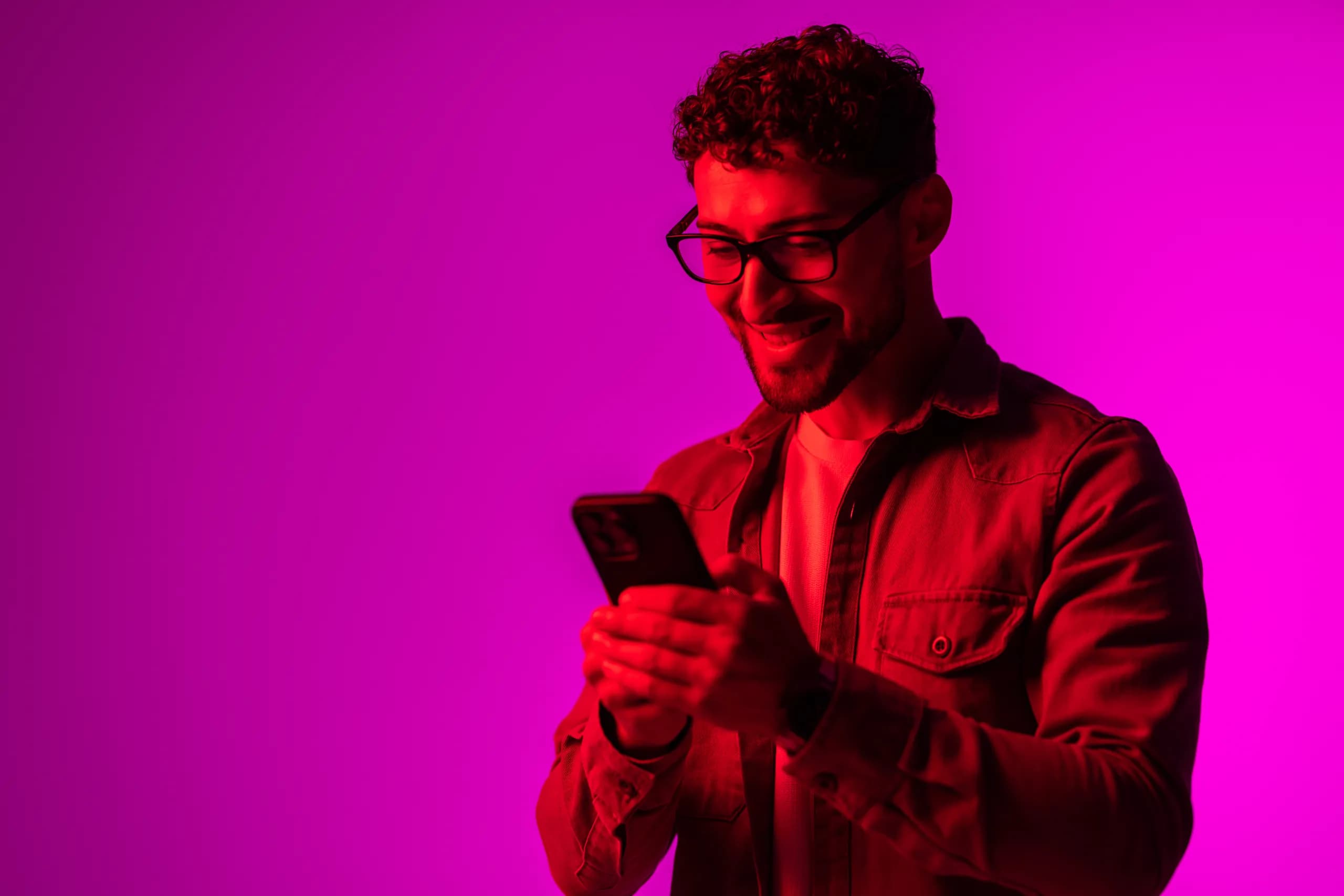 A happy customer against a neon backdrop
